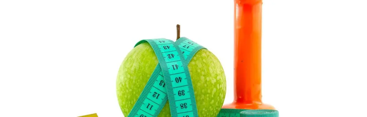 An apple, a hand weight, and a measuring tape.