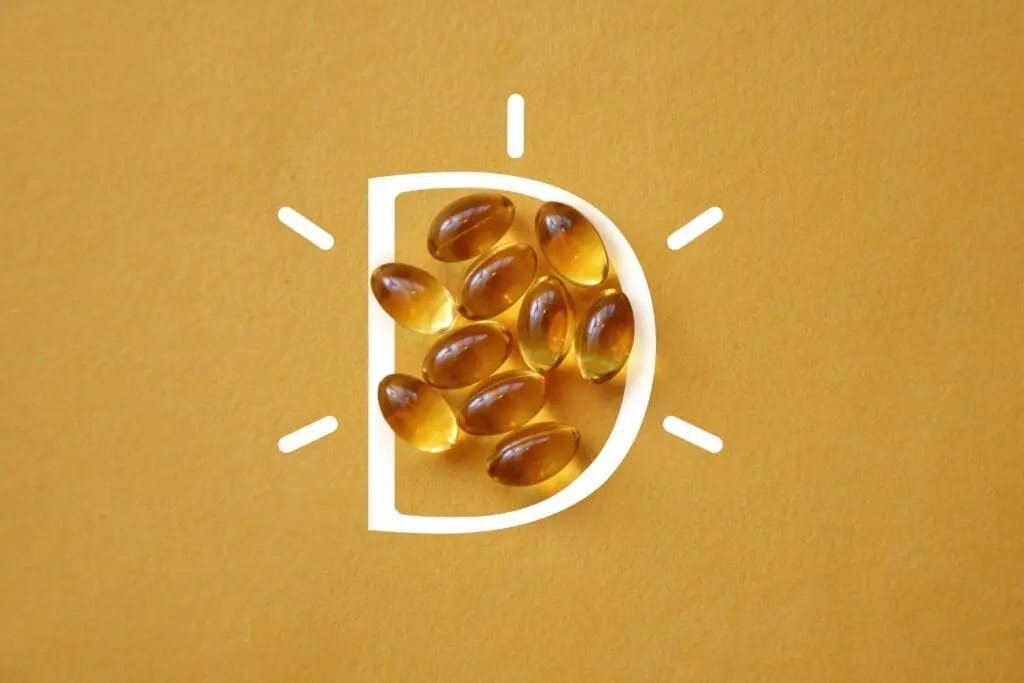 vitamin D capsules on a yellow background