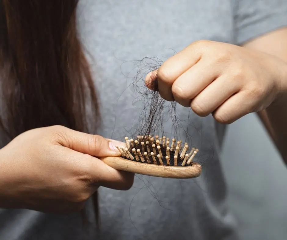 Patient brushing hair—temporary post-bariatric hair shedding (telogen effluvium)”