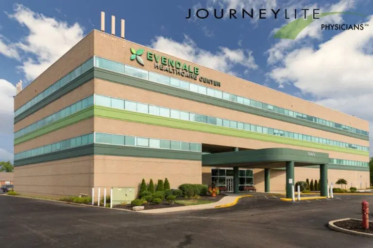 JourneyLite Physicians at Evendale Healthcare Center in Cincinnati, showing the outpatient medical building exterior under a blue sky with landscaped entrance and parking area.