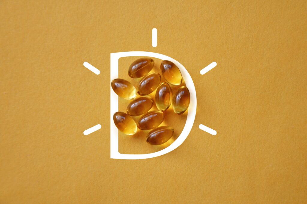 vitamin D capsules on a yellow background