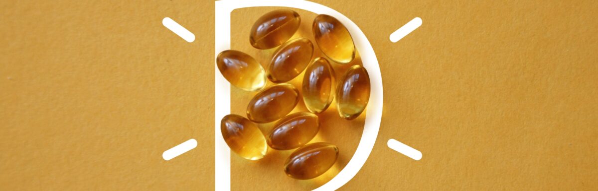 vitamin D capsules on a yellow background