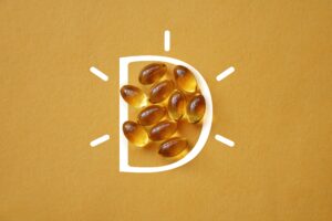 vitamin D capsules on a yellow background