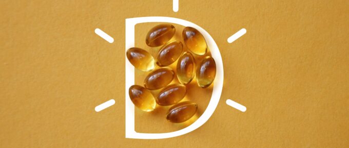 vitamin D capsules on a yellow background