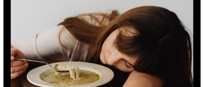 woman asleep while eating soup