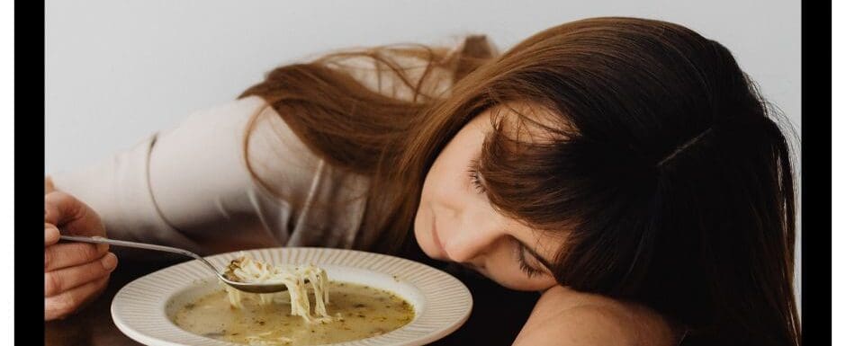woman asleep while eating soup