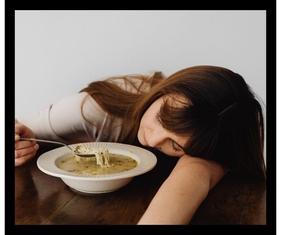 woman asleep while eating soup